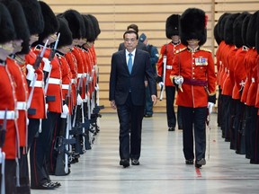Chinese Premier Li Keqiang attends a welcoming ceremony with military honours in Ottawa on Thursday, September 22, 2016. Public inconvenience and traffic flow, not the rights of protesters, were the deciding factors when a federal agency approved a visiting Chinese delegation's request for a privacy fence outside an Ottawa hotel. (THE CANADIAN PRESS/Adrian Wyld)