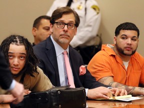 Elliot Rivera, right, Peter Pullano, defense attorney for Dennis Perez, and Dennis Perez, left, listen as Leah Gigliotti's lawyer, Brian DeCarolis speaks in Monroe Supreme Court in Rochester, N.Y., Wednesday, Nov. 23, 2016, during the sentencing for their role role in the kidnapping and torturing of two college students in Rochester last year. (Tina MacIntyre-Yee/Democrat & Chronicle via AP)