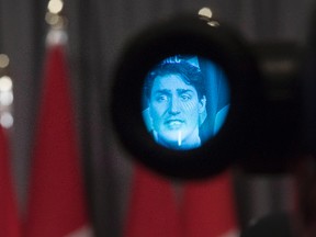 Prime Minister Justin Trudeau is pictured in the eyepiece of a television camera as he addresses the media following a summit meeting in Toronto on Nov. 14 , 2016. (THE CANADIAN PRESS/Chris Young)