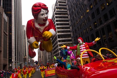 Ronald McDonald and a Ronald McDonald balloon make their way across Sixth Avenue during the Macy's Thanksgiving Day Parade, in New York, Thursday, Nov. 24, 2016. (AP Photo/Andres Kudacki)