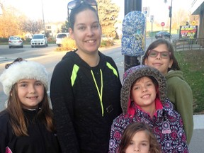 Tiffany Caughy placed 134 items, such as hats and scarves, across downtown Wallaceburg last week. Those items are in place for anyone who needs to keep warm this winter. All the items are homemade, made by either Caughy or the knitting group she belongs to. This is the second year she has done this. Her three daughters, Brooke, Aly and Jamie helped her place the items, along with their friend Isabella Silvestre, left.