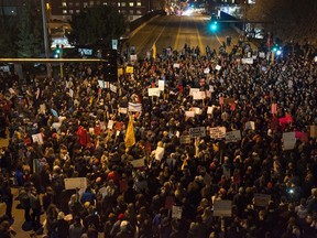 Protesters of President-elect Donald Trump gather in an intersection outside the Humphrey School of Affairs on the campus of the University of Minnesota on November 10, 2016 in Minneapolis, Minnesota. (Photo by Stephen Maturen/Getty Images)