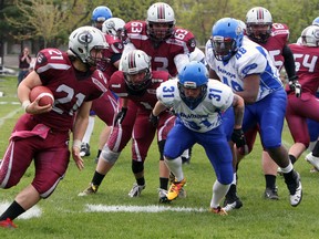 Limestone District Grenadiers' Caleb Goodfellow runs past Cumberland Panthers players during an Ontario Varsity Football League game at Loyalist Collegiate on May 21. Both organizations are joining the new Ontario Provincial Football League. (Steph Crosier/The Whig-Standard)