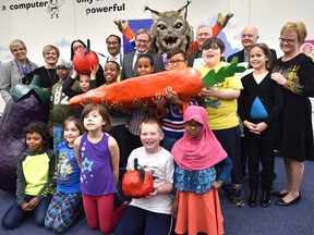 Grade 3 Rundle School students pose with officals after the Edmonton Oilers Community Foundation (EOCF) announced a $750,000 funding with a three-year commitment to E4C’s School Snack Program which serves nearly 6,000 elementary children healthy snacks or breakfast in Edmonton, Thursday, November 24, 2016. Ed Kaiser/Postmedia