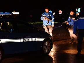 Gendarmes stand guard on a road near a retirement home for monks in Montferrier-sur-Lez, southern France, early on November 25, 2016, after an armed man burst in the home killing a woman with a knife. Armed police were hunting the man inside the home, which is home to around 70 men and women who have served as missionaries in Africa. Authorities said it was a "criminal act". (PASCAL GUYOT/AFP/Getty Images)
