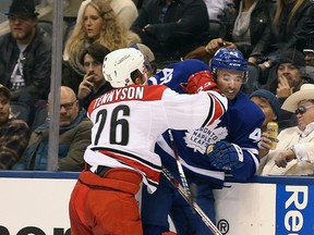 Matt Tennyson checks Nazem Kadri as the Toronto Maple Leafs take on the Carolina Hurricanes at the Air Canada Centre in Toronto on Nov. 22, 2016. (Stan Behal/Toronto Sun/Postmedia Network)