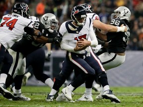 Oakland Raiders defensive end Khalil Mack gets a hand on Houston Texans quarterback Brock Osweiler during the first half of an NFL game on Nov. 21, 2016, in Mexico City. (AP Photo/Rebecca Blackwell)