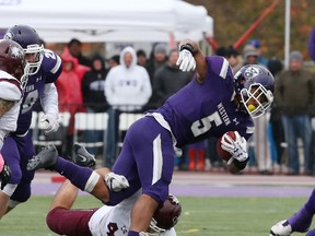 Western Mustangs running back Alex Taylor is stopped by McMaster Marauders linebacker Kyle Fitzsimons during their university football game at TD Stadium in London, Ont. on Saturday October 22, 2016. (Free Press file photo)