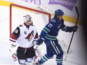 Vancouver Canucks defenceman Ben Hutton scores the game-winning goal during NHL action in Vancouver on Nov. 17, 2016. (THE CANADIAN PRESS/Jonathan Hayward)
