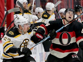 Bruins’ Brad Marchand gets his stick up on Senators’ Jean-Gabriel Pageau during Thursday night's game at the Canadian Tire Centre. (JULIE OLIVER/POSTMEDIA NETWORK)