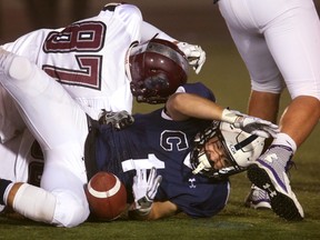 South's Cole Wilkinson tackles Derek Aubin of CCH and the ball comes loose but he was ruled down on the play in the first quarter of their WOSSAA (city final) on Thursday, November 24 in London, Ont. (MIKE HENSEN, The London Free Press)