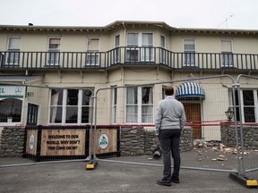New Zealand Prime Minister John Key inspects damage to the Waiau Lodge Hotel in Waiau, New Zealand, on Thursday, Nov. 24, 2016, after a magnitude 7.8 earthquake hit the region 10 days earlier. (Iain McGregor/Christchurch Press/Pool via AP)