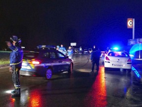 French Gendarmes control cars near the village of Montferrier-sur-Lez, southern France, Friday, Nov. 25, 2016. The French gendarmerie says a masked gunman has burst into a retirement home for monks in southern France and killed an elderly woman with a knife. The press service for the national military police couldn't immediately say whether the incident is linked to a terror act or not. (AP Photo)