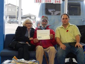 Alma and Raymond Bennett were awarded a certification of appreciation by Chris Halter, owner of Grove AutoPro and Tire in Spruce Grove, for Raymond Bennett’s military service during the Second World War. - Photo supplied