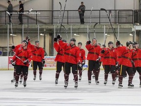 Virden Oil Capitals, dressed in RCMP-styled uniforms, salute their fans after posting a 4-1 victory over the Portage Terriers.