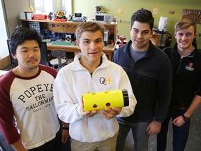 Third-year Queen’s University students, from left, Andy Tsuno, Marnus Coetsee, Arthur Cockfield and John Dick display on Wednesday a prototype of a pod the team is developing for the SpaceX Hyperloop Pod Competition. (Elliot Ferguson/The Whig-Standard)