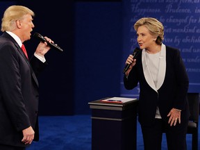 In this Sunday, Oct. 9, 2016, file photo, Donald Trump and Hillary Clinton speak during the second U.S. presidential debate at Washington University in St. Louis. (AP Photo/John Locher, File)