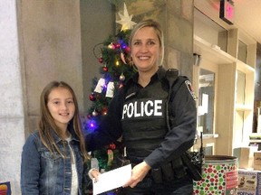 This past May, 10-year-old Ailsa, whose last name was not released by Kingston Police, was walking home in Kingston's east end when she discovered about $900 in cash. The young philanthropist is donating the money to a local youth shelter and animal rescue facility. (Courtesy Kingston Police)