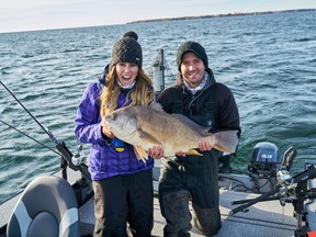 Ashley Rae (left) and her fishing partner, Eric Riley, with a 19-pound freshwater drum caught and released on the Bay of Quinte. (Supplied photo)