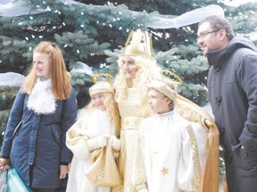 Visitors to Kitchener?s Christkindl Market can get their photo taken with Christkindl and her two angels. (Special to Postmedia News)