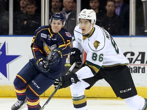 London Knights defenceman Chris Martenet looks up ice ahead of Barrie Colts forward Kyle Heitzner on Friday night. (CRAIG GLOVER, The London Free Press)