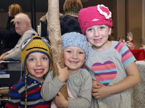 John Lappa/Sudbury Star
Max Whissell, 3, left, and his sisters, Madison, 3, and Payton, 5, try winter apparel on for size at the Christmas craft show at Pioneer Manor in Sudbury on Friday. The event continues Saturday and Sunday from 10 a.m. to 4 p.m.