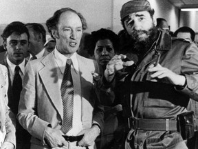 Prime Minister Pierre Trudeau looks on as Cuban President Fidel Castro gestures during a visit in Havana on Jan. 27, 1976. THE CANADIAN PRESS/Fred Chartrand