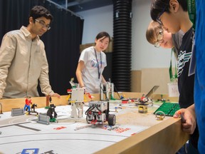 Members of the Electro Beasts, one of two FIRST Lego League teams working at the University of Alberta medical faculty's Rehabilitation Robotics Lab, program a robot to perform tasks on Nov. 26, 2016. Shaughn Butts / Postmedia