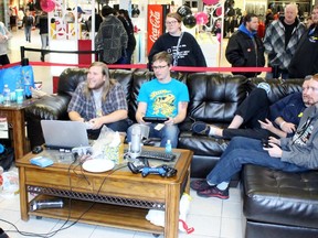 From left seated on the couch, Max Major, Wade Alexander, Cian Poore and Darryl Heater play a video game in a temporary living room set up inside Lambton Mall on Saturday, Nov. 26, 2016 in Sarnia, Ont. The group organized a 24-hour marathon called Playing for Charity which raised funds for Big Brothers Big Sisters of Sarnia-Lambton. Terry Bridge/Sarnia Observer/Postmedia Network