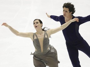 Tessa Virtue and Scott Moir of Canada perform during the ice dance event at the NHK Trophy figure skating competition in Sapporo, Japan on Nov. 27, 2016. (Hiroki Yamauchi/Kyodo News via AP)