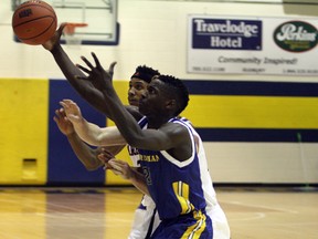 Laurentian Voyageurs' Litha Ncanisa beats a pair of Carleton Ravens to a loose ball during OUA men's basketball action at the Ben vaery Gym in Sudbury on Saturday, Nov. 25, 2016. Ben Leeson/The Sudbury Star/Postmedia Network