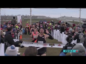 Lively's Ross Proudfoot holds up two fingers as he crosses the finish line to win his second straight Canadian national cross-country running championship on Saturday in Kingston. Special to The Star