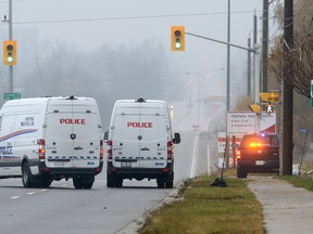 Police vehicles in the intersection of Richmond Street and Sunningdale Road investigating a head-on collision on Sunningdale Road that killed a woman driver in a car on Thursday Nov 24, 2016. (MORRIS LAMONT, The London Free Press)