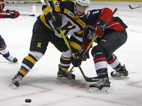 Kingston Frontenacs’ Nathan Dunkley ties up Windsor Spitfires’ Connor Corcoran during Ontario Hockey League action at the Rogers K-Rock Centre on Sunday. (Steph Crosier/The Whig-Standard)