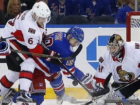 Ottawa Senators goaltender Craig Anderson (41) makes a save on a shot by New York Rangers' Jesper Fast (19) as Senators' Chris Wideman (6) helps out during the first period of an NHL hockey game in New York, Sunday, Nov. 27, 2016. (AP Photo/Rich Schultz)