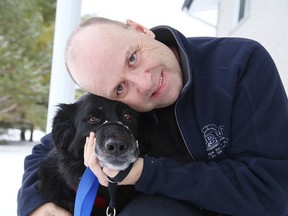 Robert Simoneau spends time with his dog Ebony in Chelmsford. Simoneau will perform in a standup comedy fundraiser to help pay for Ebony's medical expenses. (Gino Donato/Sudbury Star)