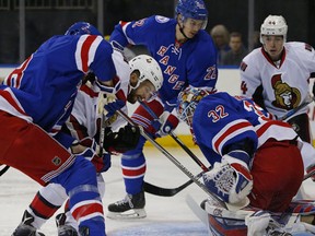 New York Rangers goaltender Antti Raanta prepares to make a save as teammate Marc Staal helps keep Ottawa Senators' Tom Pyatt from the puck during the first period of an NHL hockey game in New York, Sunday, Nov. 27, 2016. (AP Photo/Rich Schultz)