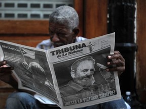 A man reads a newspaper in a street of Havana, on November 27, 2016, two days after Cuban leader Fidel Castro died. Cuban revolutionary icon Fidel Castro died late November 25 in Havana, his brother, President Raul Castro, announced on national television. Castro's ashes will be buried in the historic southeastern city of Santiago on December 4 after a four-day procession through the country. (PEDRO PARDO/AFP/Getty Images)