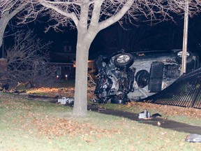 The mini van at rest on its side against the fence at Judith Gooderham Park. (Darryl Coote/The Goderich Signal Star)