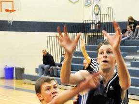 Noah Price of the Mitchell District High School (MDHS) senior boys basketball team reaches for an in-bounds pass under the basket during action from the Mitchell Bowl basketball tournament last Friday, Nov. 25 against North Middlesex, a 47-35 win. ANDY BADER MITCHELL ADVOCATE