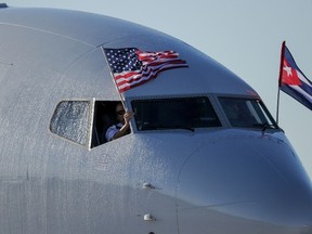 An American Airlines plane fluttering US and Cuba national flags is seen uppon arrival at Jose Marti International Airport becoming the first Miami-Havana commercial flight in 50 years, coinciding with the beginning of the tributes to late Cuban leader Fidel Castro, on November 28, 2016 in Havana. (YAMIL LAGEYAMIL LAGE/AFP/Getty Images)