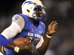 In this Saturday, Sept. 21, 2013, file photo, then-Air Force quarterback Jaleel Awini runs 33 yards for a touchdown in the first quarter of an NCAA college football game against Wyoming at Falcon Stadium in Air Force Academy, Colo.