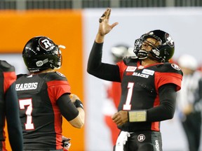 Ottawa QB Henry Burris (right) tied a Grey Cup record with 35 completions in 46 attempts. (Michael Peake/Postmedia Network)