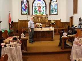 James Freake of the Holy Trinity Anglican Church is surrounded by sheep before they wandered away to sit on local businesses shelves.