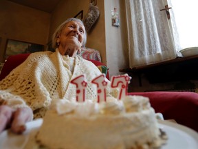 Emma Morano holds a cake with candles marking 117 years in the day of her birthday in Verbania, Italy, Tuesday, Nov. 29, 2016. At 117 years of age, Emma is now the oldest person in the world and is believed to be the last surviving person in the world who was born in the 1800s, coming into the world on Nov. 29, 1899. (AP Photo/Antonio Calanni)