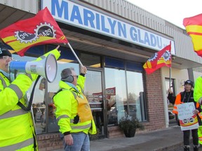 Maria Baldesarra leads a chant by striking Blue Water Bridge workers and supporters picketing Tuesday morning outside the Sarnia office of Sarnia-Lambton MP Marilyn Gladu. Members of the Public Service Alliance of Canada at the bridge went on strike Nov. 21. (Paul Morden/Sarnia Observer/Postmedia Network)