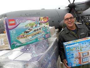 Ernst Kuglin/The Intelligencer
8 Wing/CFB Trenton CWO Darcy Elder holds one of the donated toys bound for Goose Bay Wednesday. Thousands of toys collected through the Royal Canadian Mounted Police Toys for the North program will be delivered to children living in northern communities of Ontario, and Labrador.