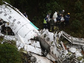Rescue teams recover the bodies of victims of the LAMIA airlines charter that crashed in the mountains of Cerro Gordo, municipality of La Union, Colombia, on November 29, 2016 carrying members of the Brazilian football team Chapecoense Real. (RAUL ARBOLEDA/AFP/Getty Images)