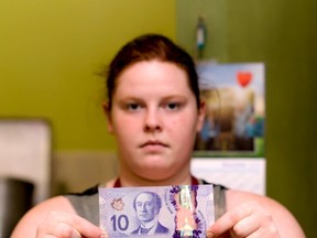 Madison Dunkley, staff member at KJ’s Sandwich Bar, holds up a fake (bottom) and real $10 bill on Nov. 23, 2016. Since Aug. 1, 2016 Whitecourt RCMP have recieved 15 reports of counterfeit money being passed off as genuine in town. “The small businesses in town are the ones that are going to end up losing out if we don’t get it under control,” Const. Penney said.

Hannah Lawson |  Whitecourt Star