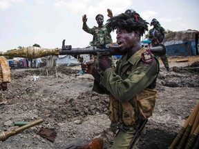 Albert Gonzalez Farran/AFP/Getty Images
Soldiers of the Sudan People Liberation Army celebrate while standing in trenches in Lelo, outside Malakal, northern South Sudan, in October. Heavy fighting broke out on Oct. 14 between SPLA (government) and opposition forces in Wajwok and Lalo villages, outside Malakal.